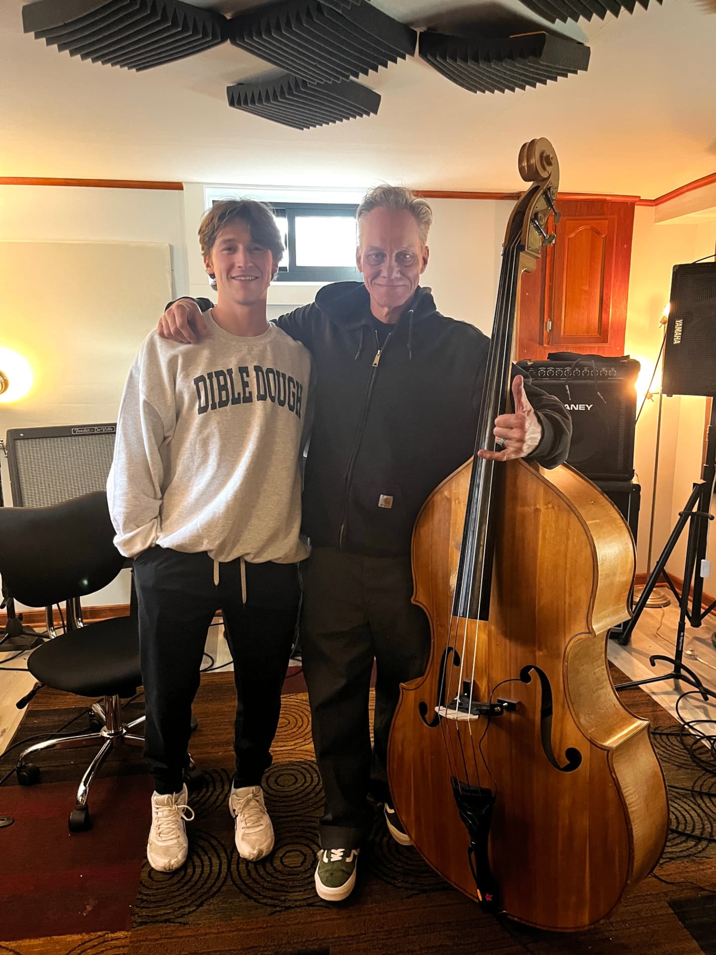 Cam and his cousin Dave Eckles with an upright bass in the studio