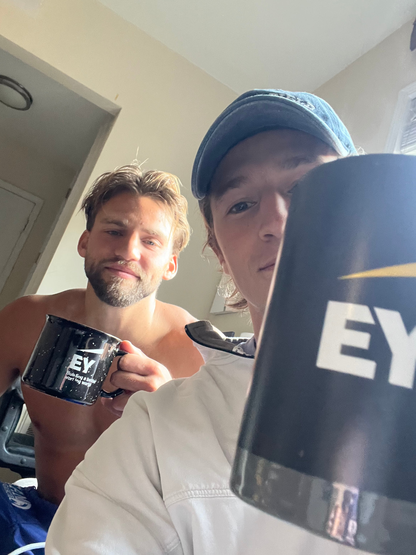 Cam and a friend holding EY mugs