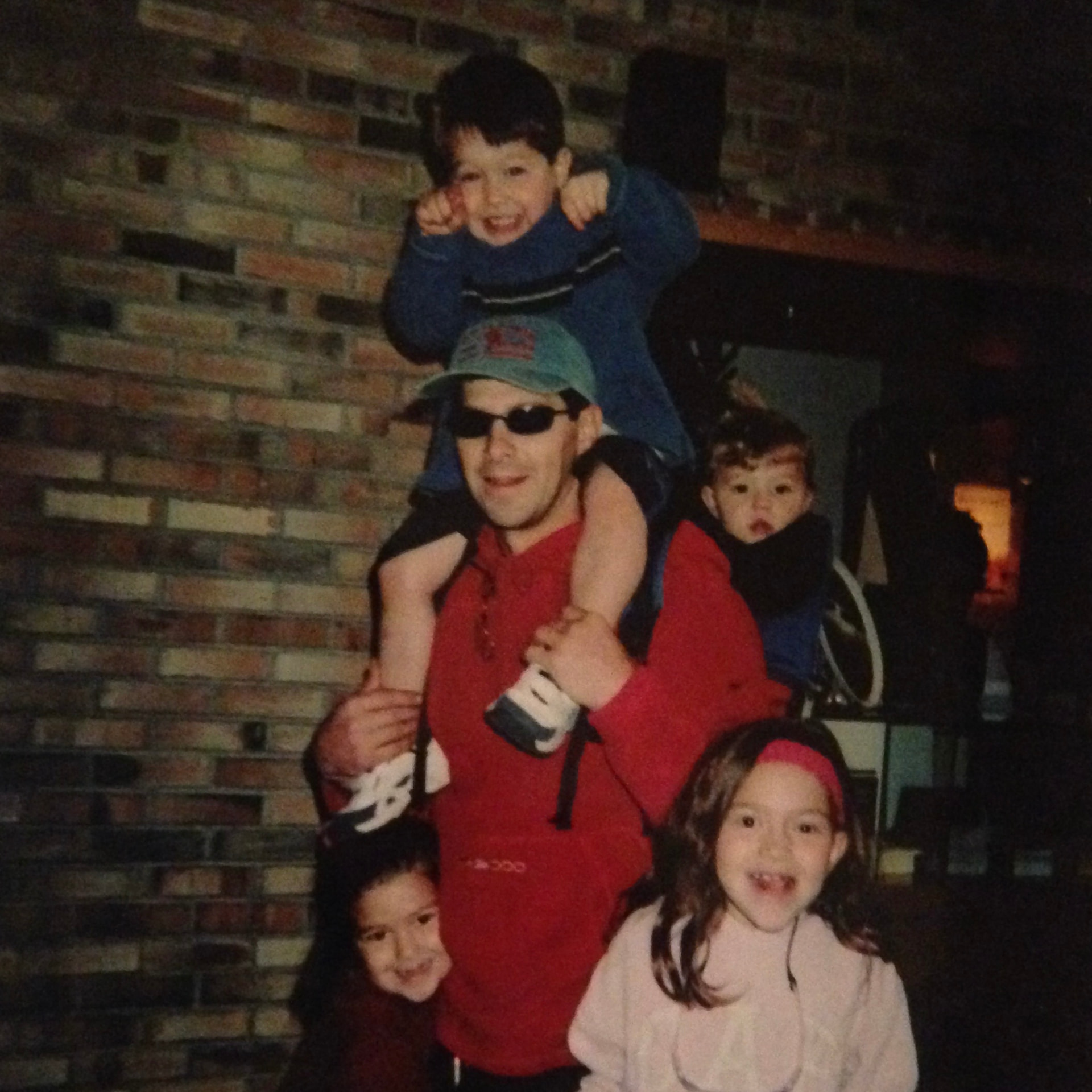 Cam's dad carrying the kids on his shoulders, circa 2004
